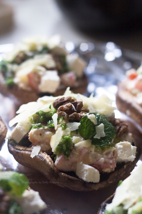 Portobello mushrooms topped with feta, walnuts, sour cream, pesto, tomatoes, mint leaves